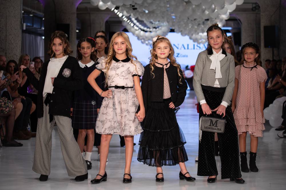 A group of child models on a catwalk for the Glam Z Gala fashion show