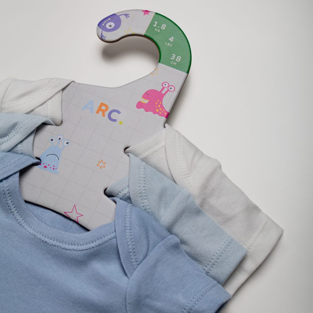 Cardboard hangers displaying babywear 