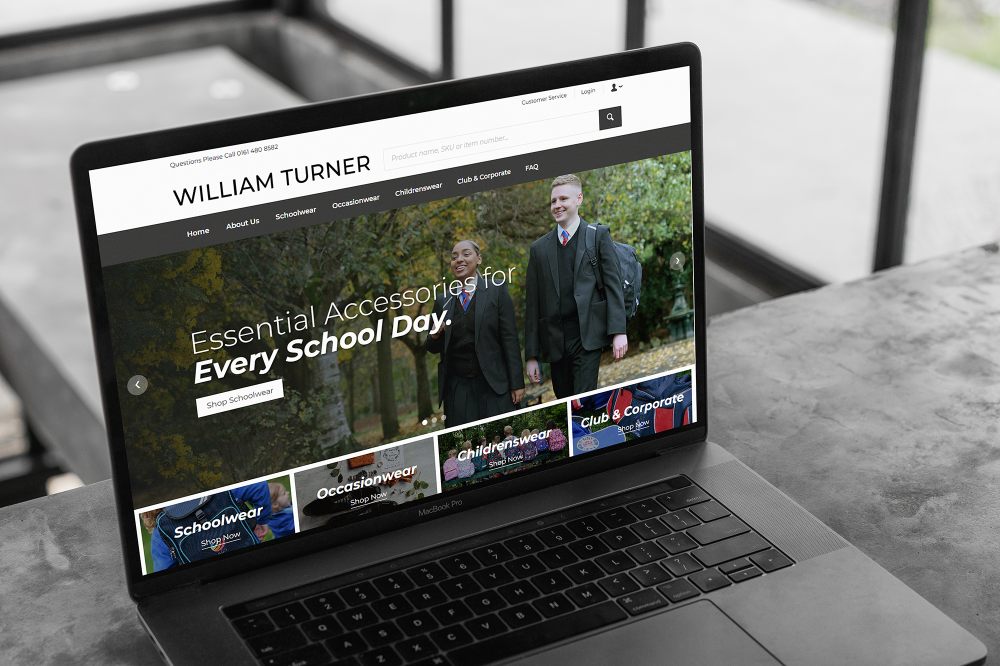 A laptop on a table showing the homepage of the new William Turner website