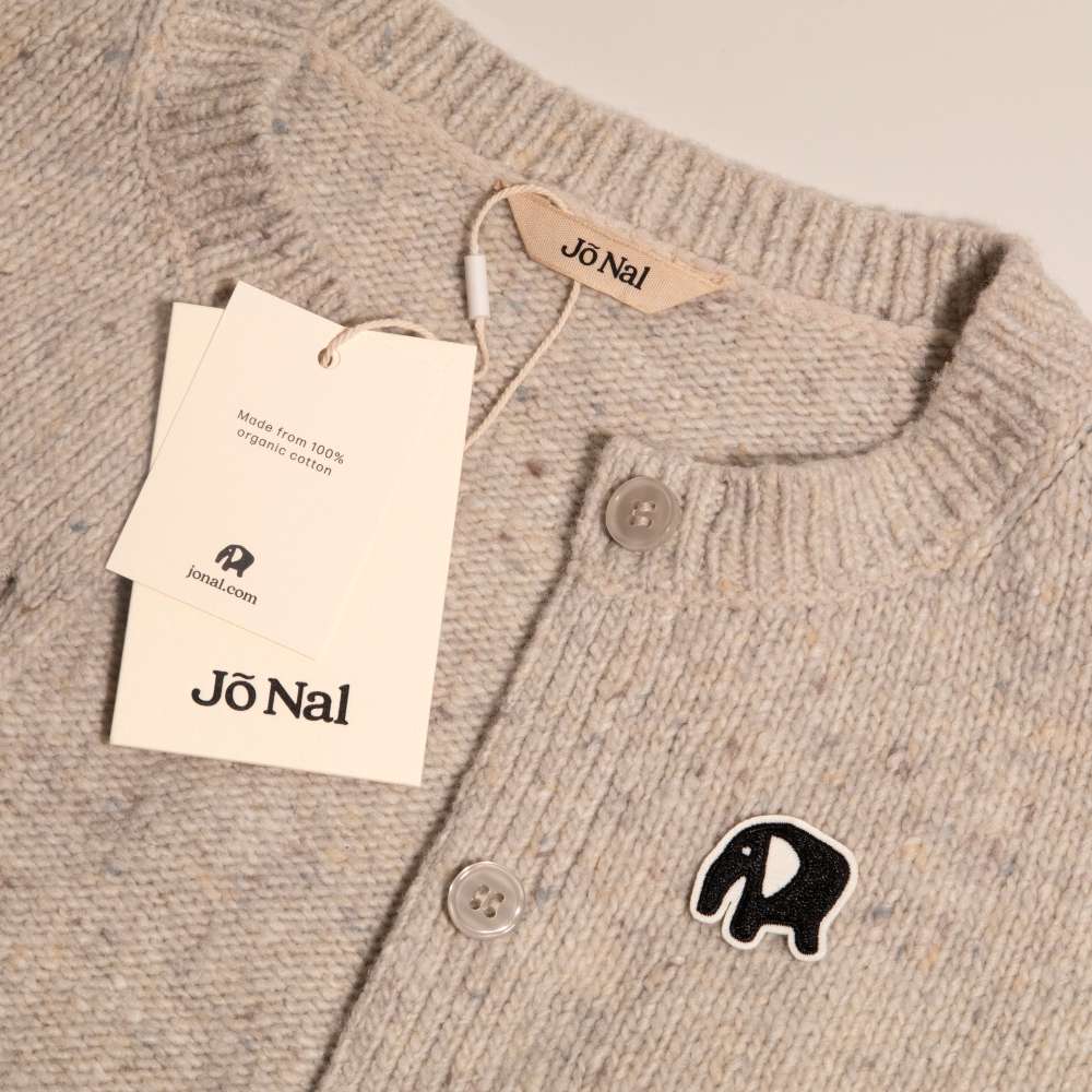 A wooly jumper with tase featuring the brands brand identity