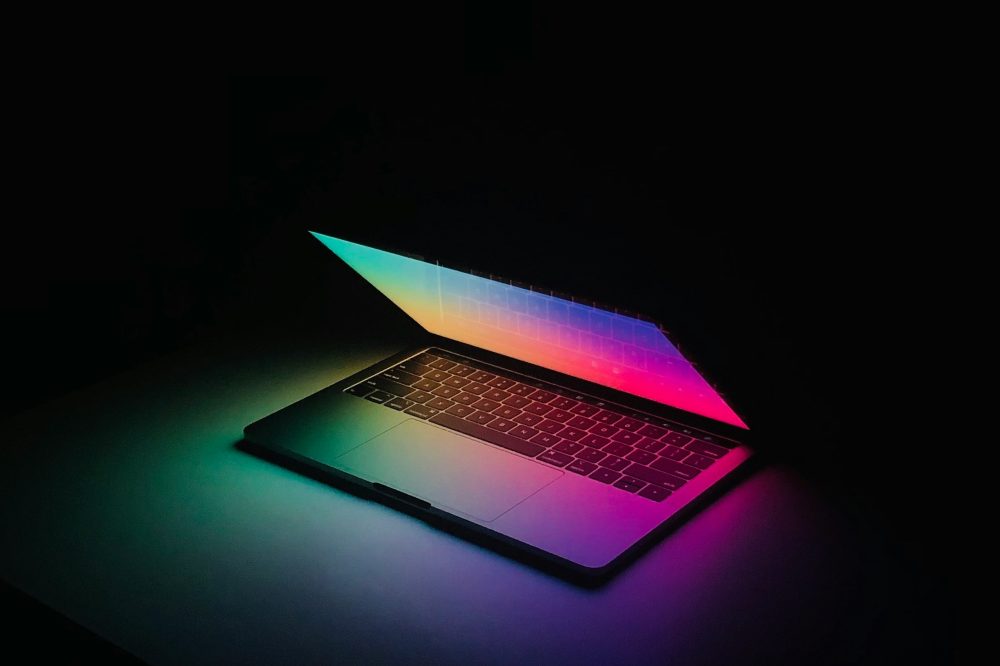 A laptop lit up in the dark