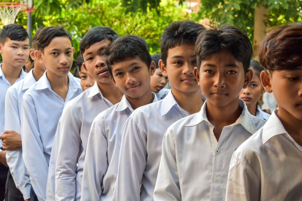 Cambodian children stood outside in school uniform 