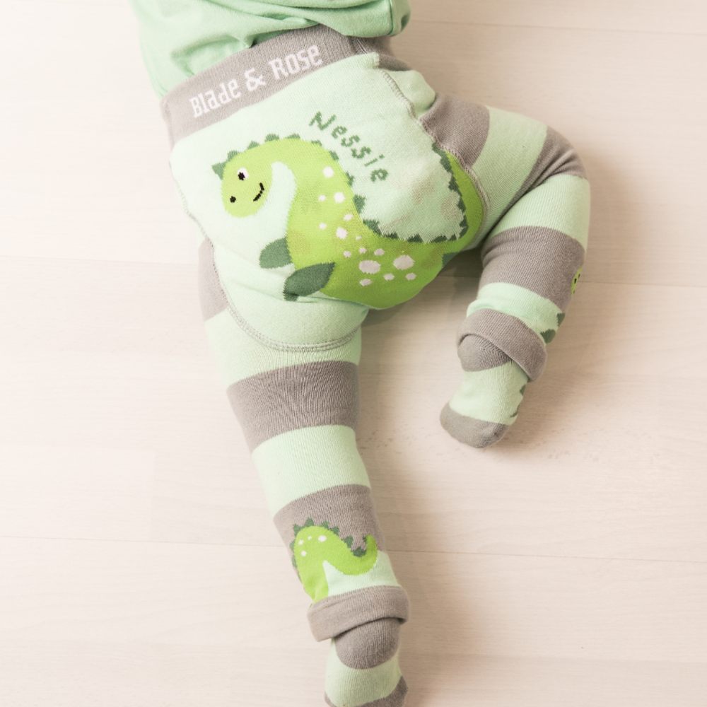 A baby shown crawling wearing green and grey Nessie leggings by Blade & Rose 