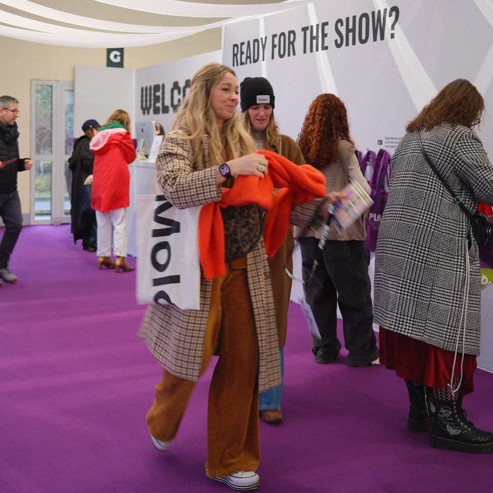 A woman walking into the entrance of the Playtime Paris trade show 