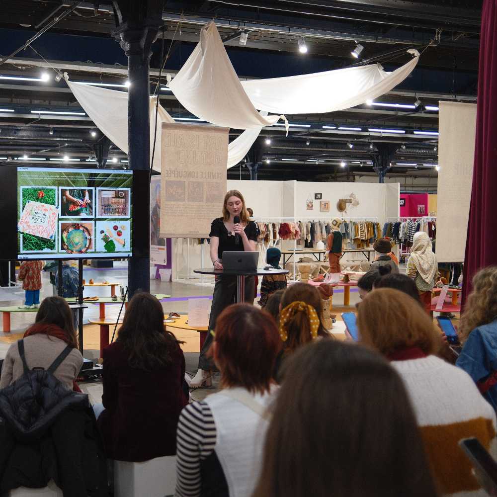Someone doing a talk to a crowd of people at Playtime Paris 