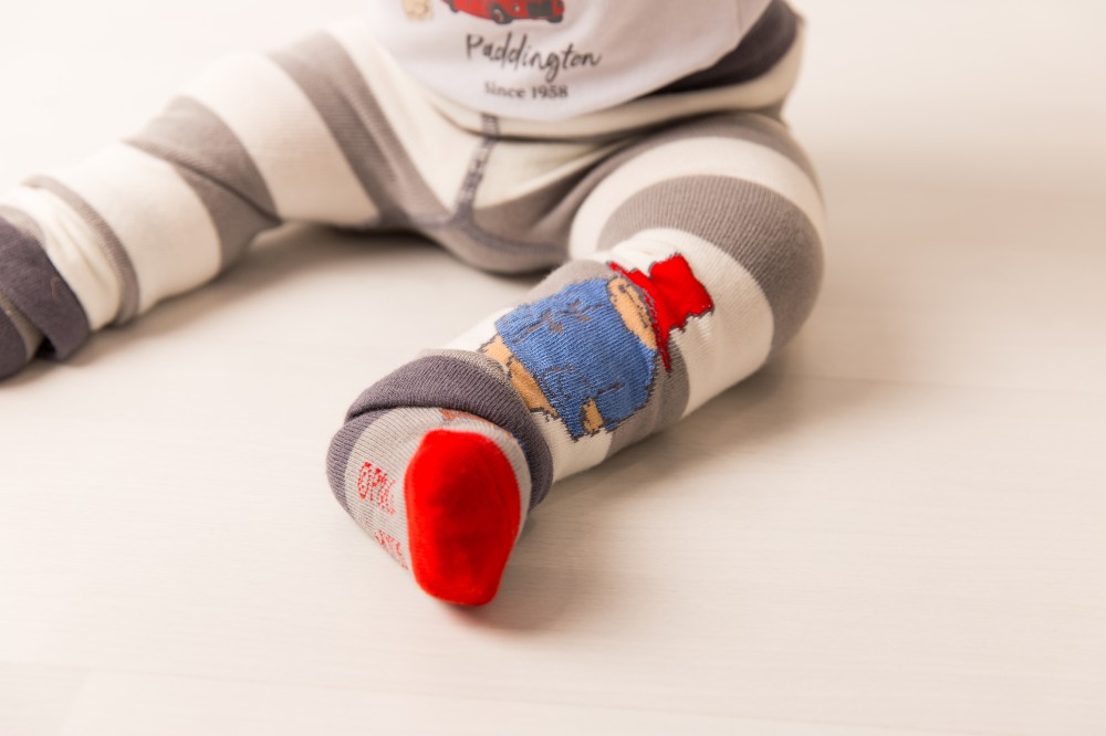 A baby's legs shown sat down wearing leggings from the Paddington Loves to Travel Collection by Blade & Rose