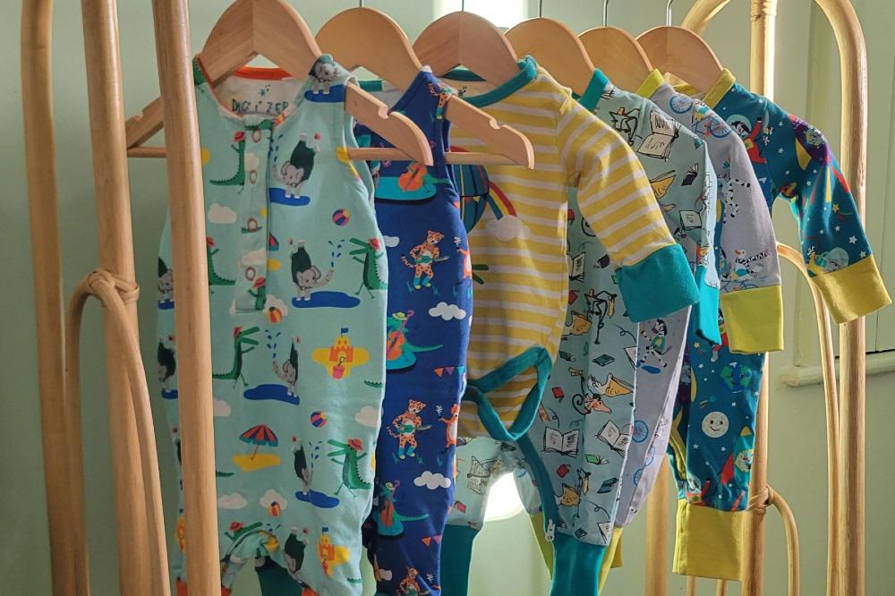 Children's clothes hung on a wooden rail