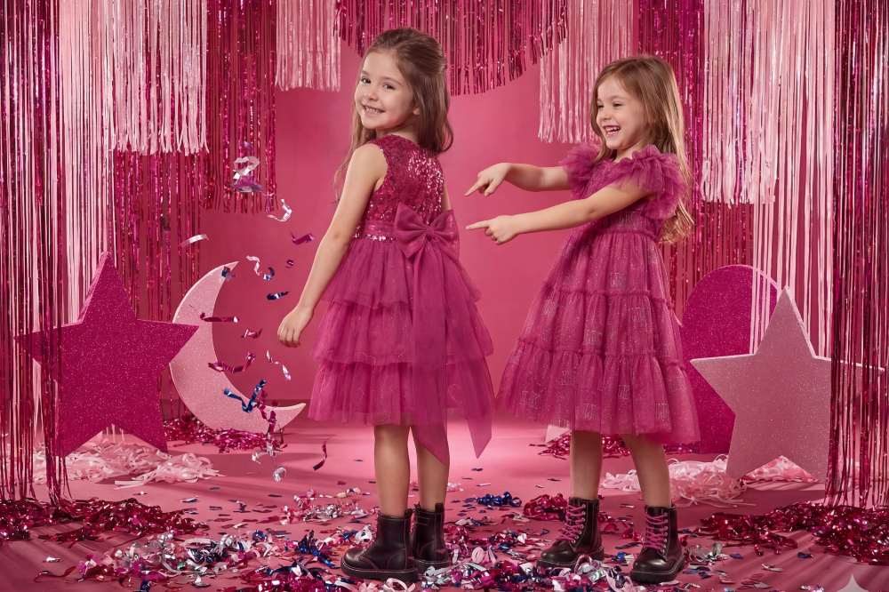 Two girls in pink party dresses by Lelli Kelly Clothing