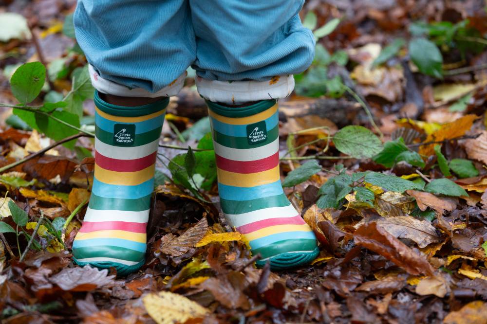 A child's feet shown outside wearing striped wellington boots by Little Green Radicals 