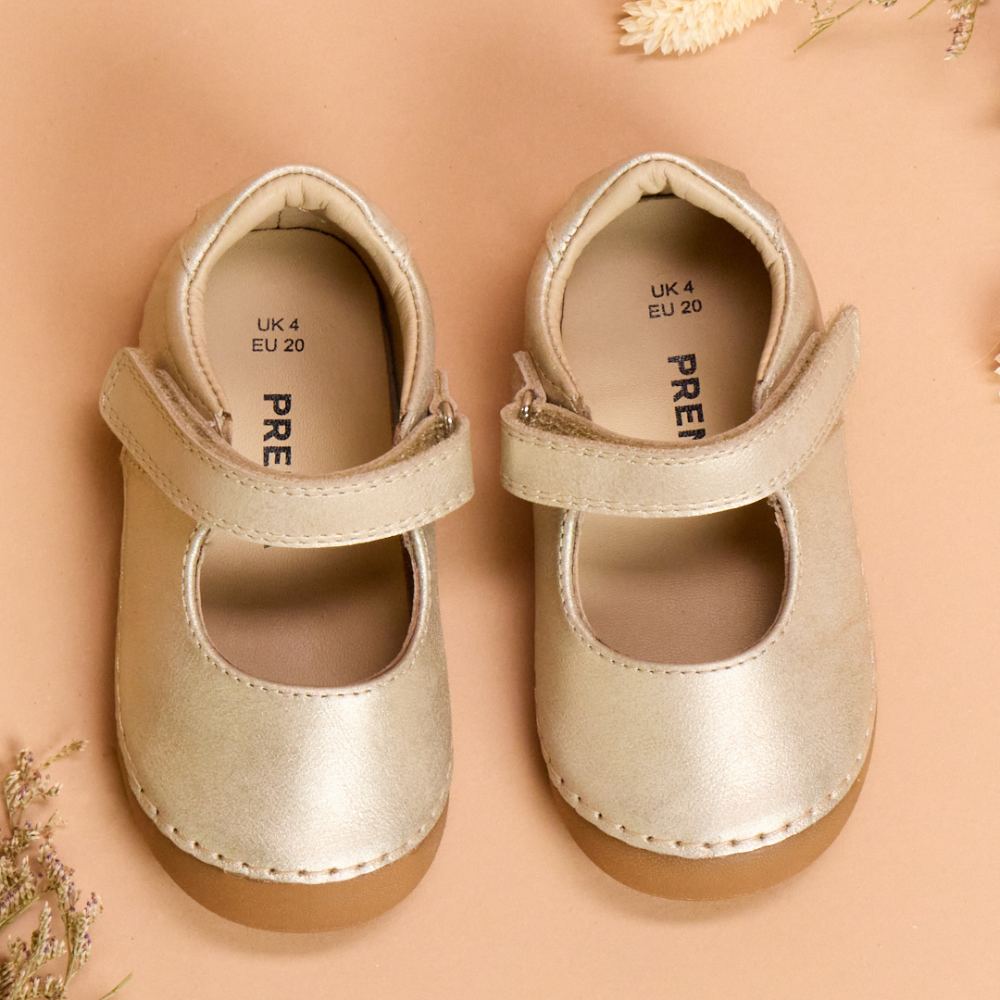 A pair of gold Mary Jane children's shoes by PRENTA