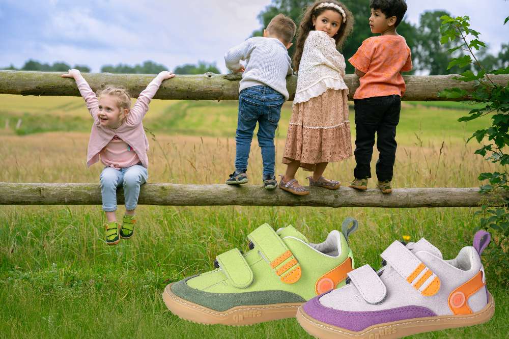 Children outside in a field stood on a wooden fence wearing summer outfits and barefoot shoes by QNUFFS