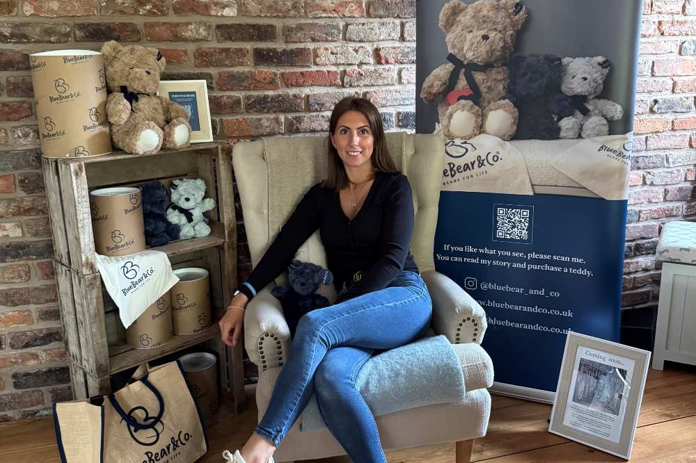 Nici Robinson, founder of Blue Bear Co., sat in a chair surrounded by products