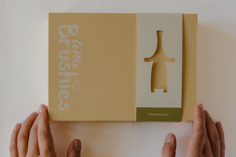 Someone holding a packaging box for the Brushie Bear by Little Brushies