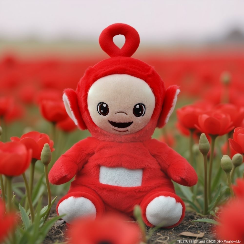 A red Teletubbies toy by Warmies displayed amongst red poppies 