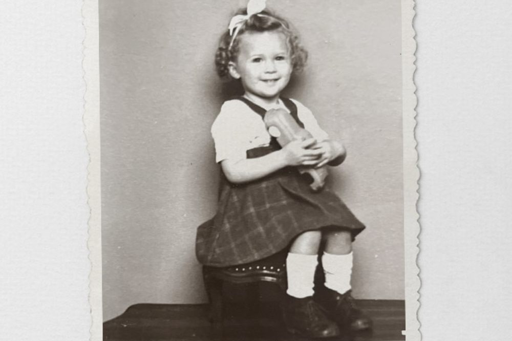 A black and white photo of a young girl wearing Bundgaard shoes for the Loved by Children. For Generations. campaign
