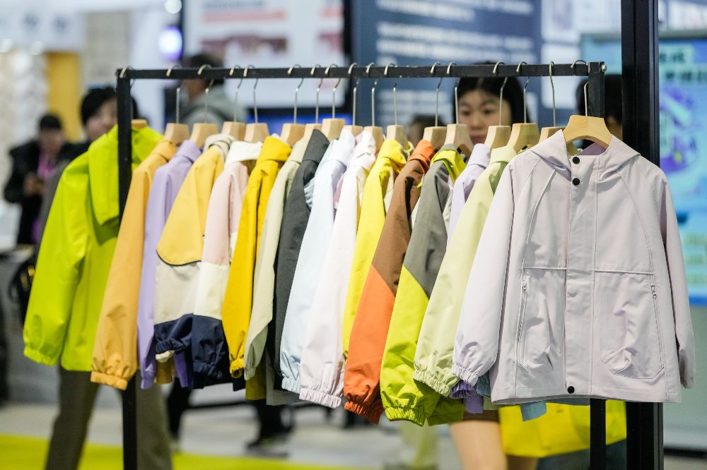 A rail of children's outdoor coats at the CHIC Kidz trade show