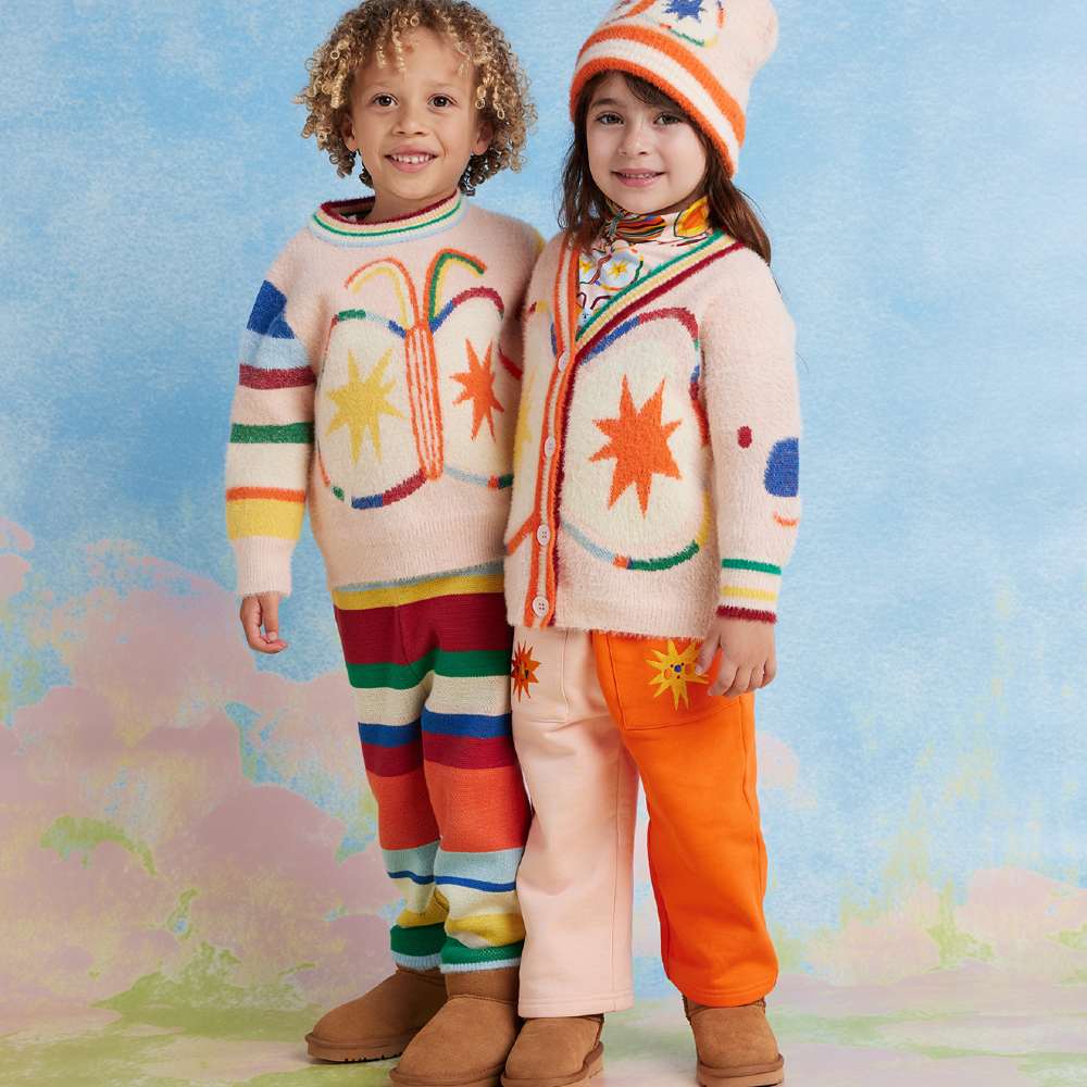 Two children in brightly coloured winter outfits 