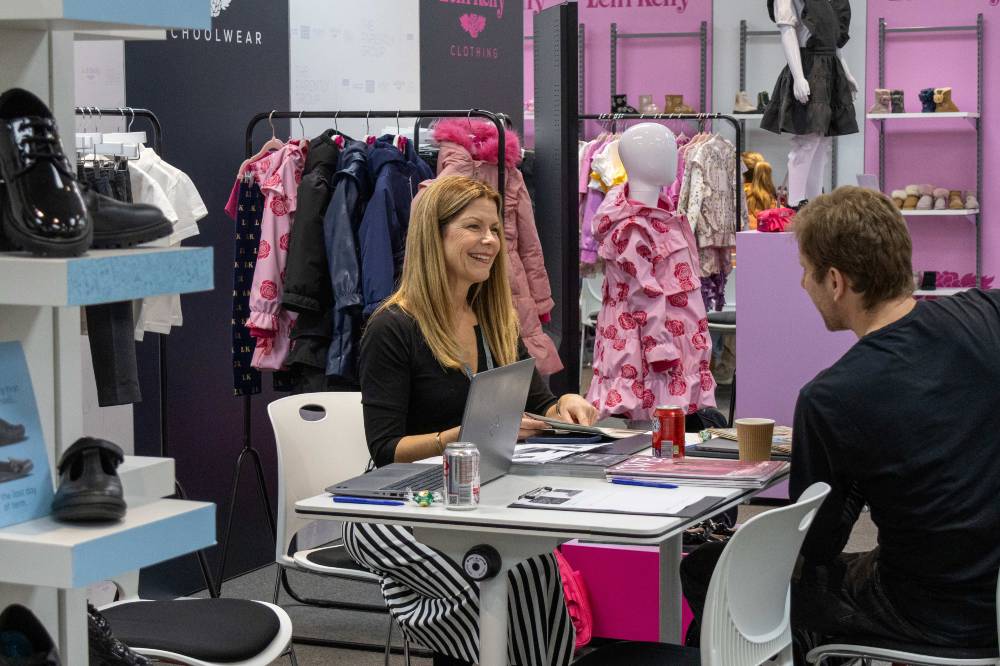People on a stand at INDX National Kidswear and Kids Footwear Shows