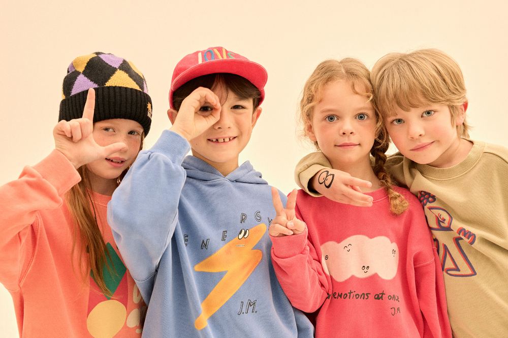 Four children in brightly coloured tops
