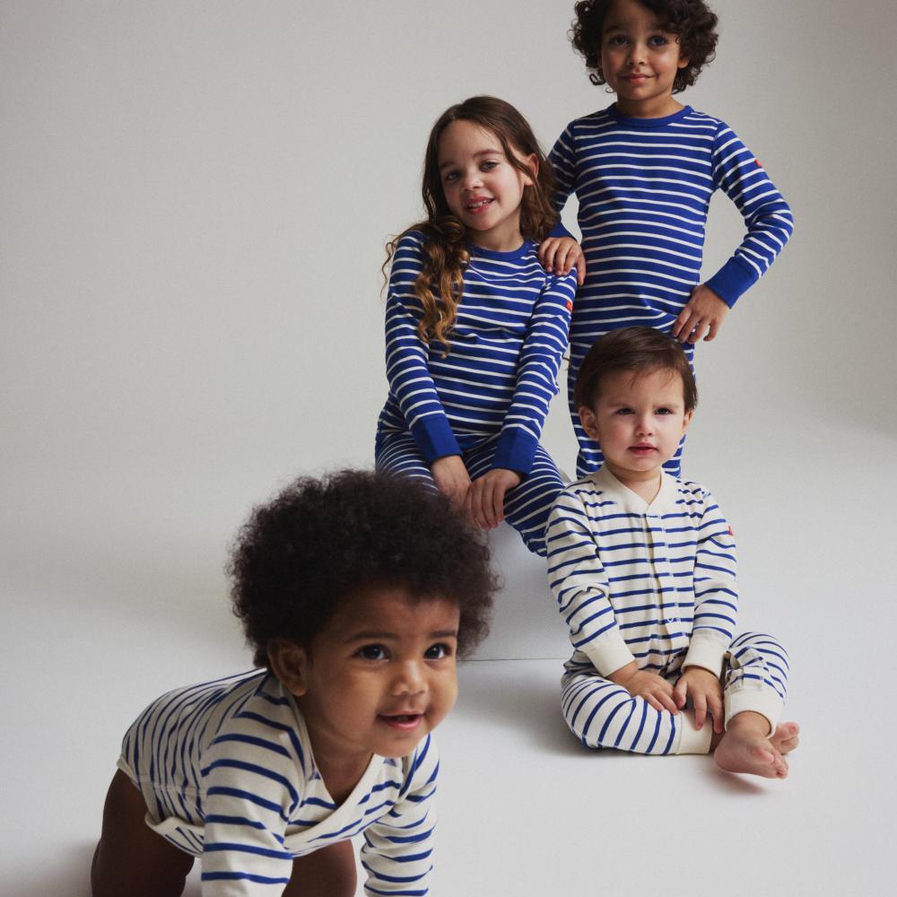 A group of children wearing blue and white striped outfits from PO.P's limited 50th anniversary collection