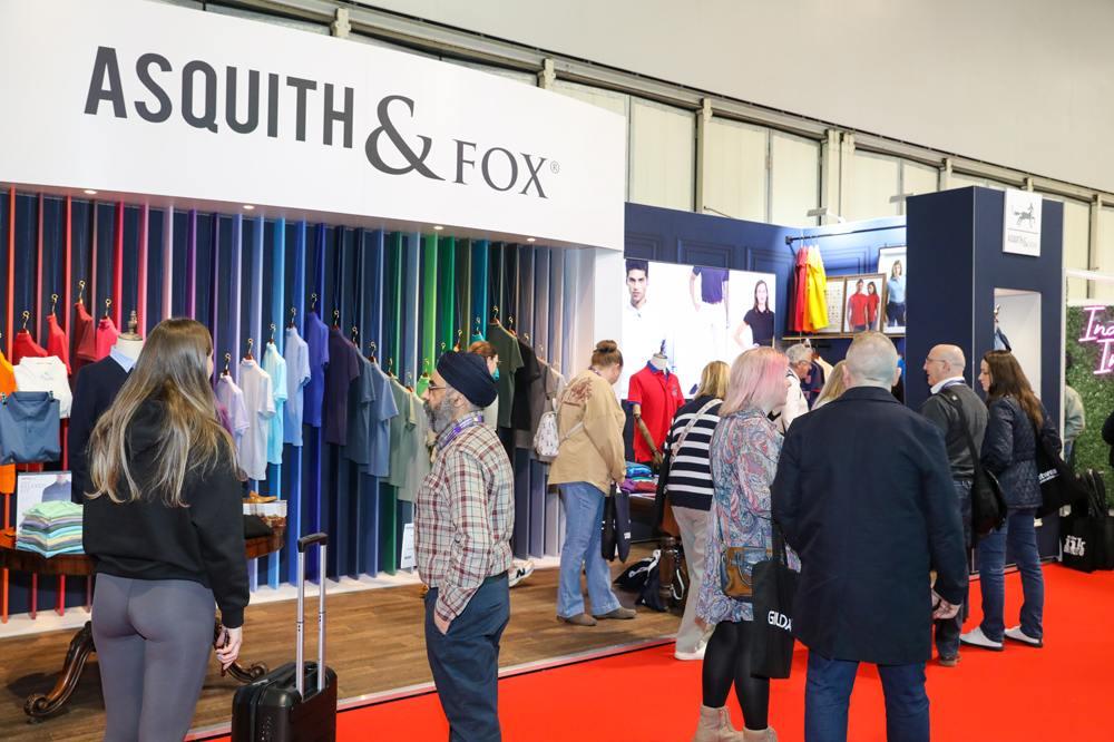 People stood on an exhibitor's stand at Printwear & Promotion LIVE! 2026 