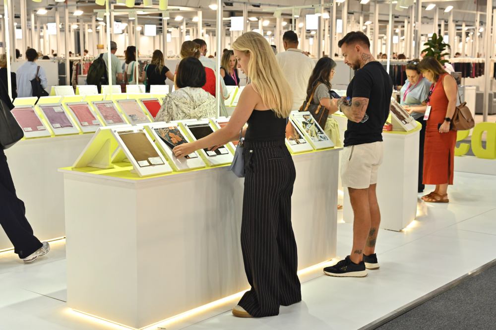 People looking at fabric samples at Texhibition