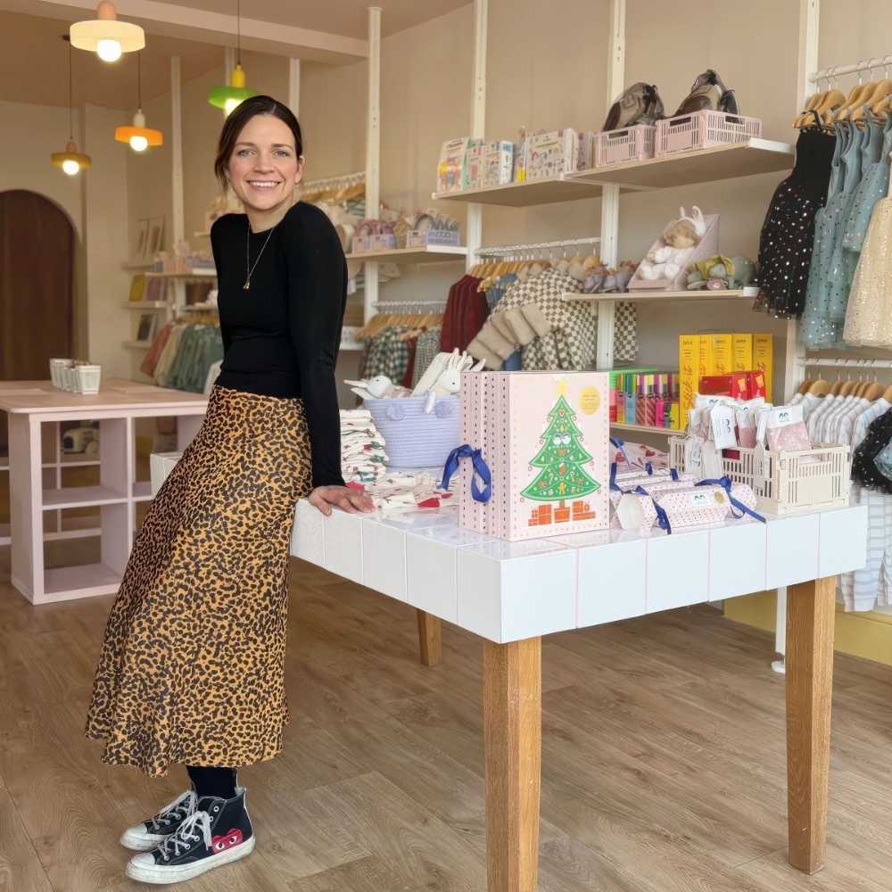 A woman leant against a table in the Cucurucu children's store in Conwy 