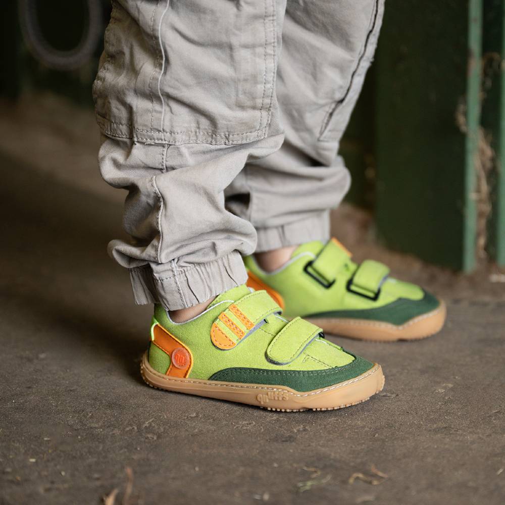 A child's feet shown wearing brightly coloured shoes by Qnuffs