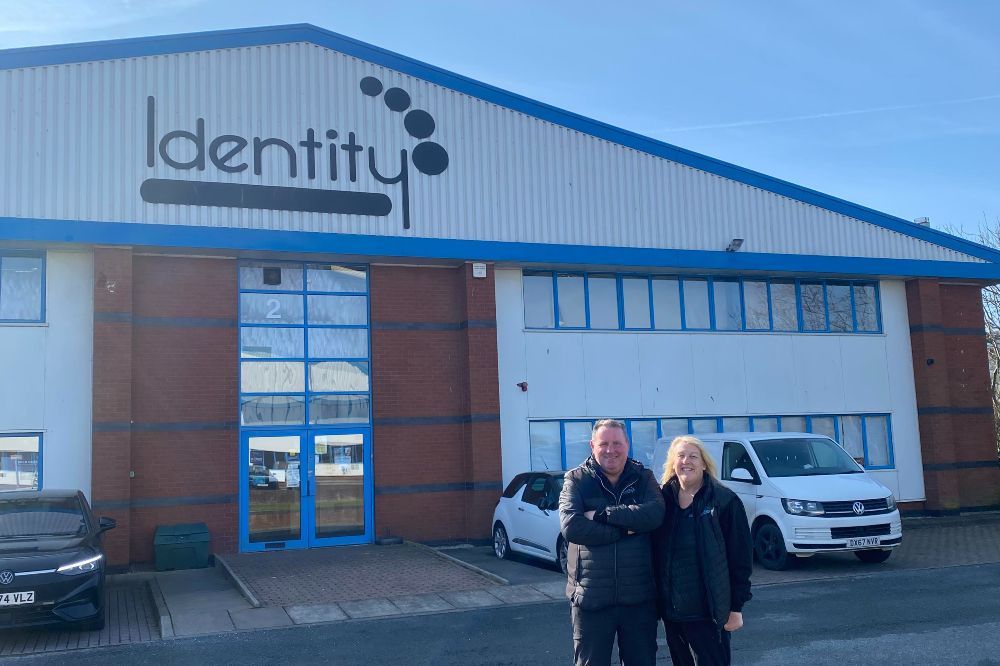 Two people stood outside the premises of Identity