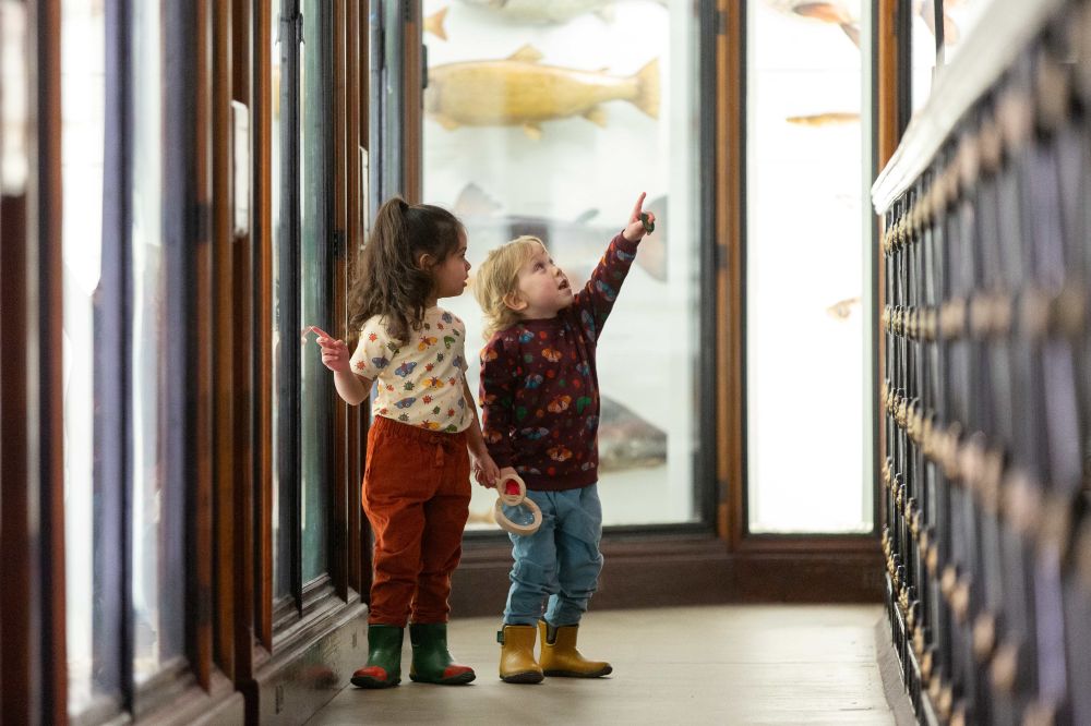 Two children in the Natural History Museum wearing outfits b y Little Green Radicals 