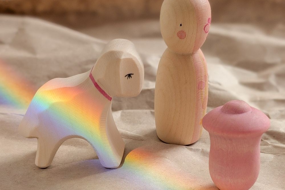 Children's wooden toys displayed in sand