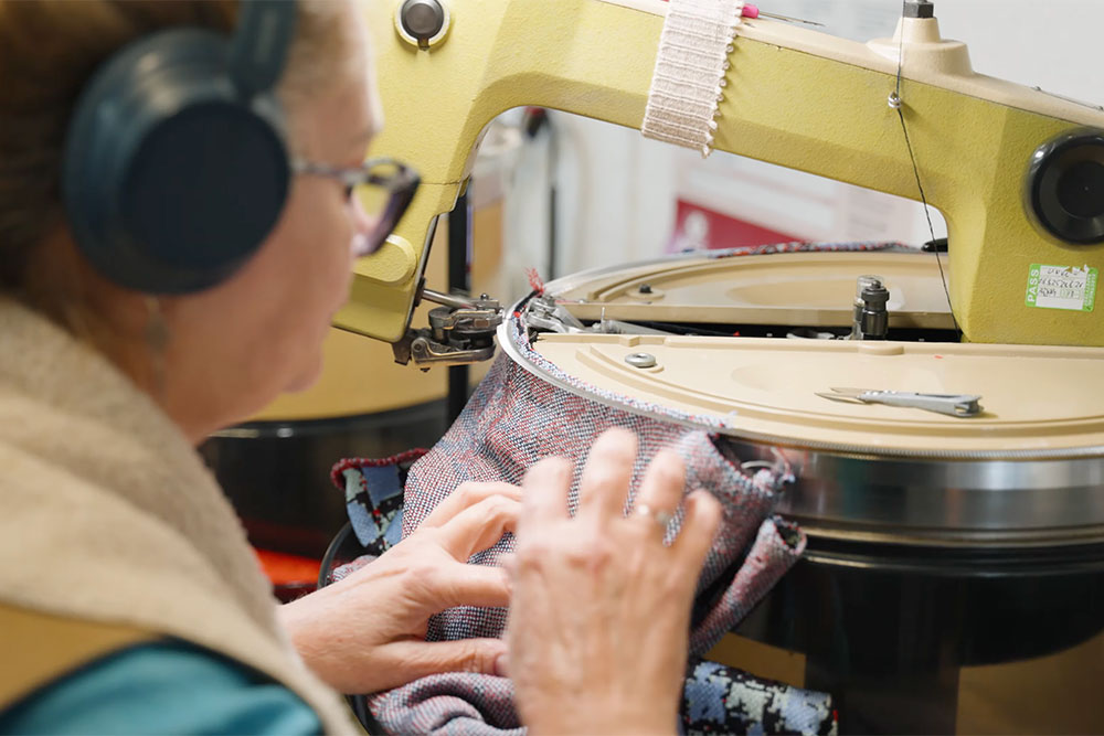 A woman creating a garment on a sewing machine