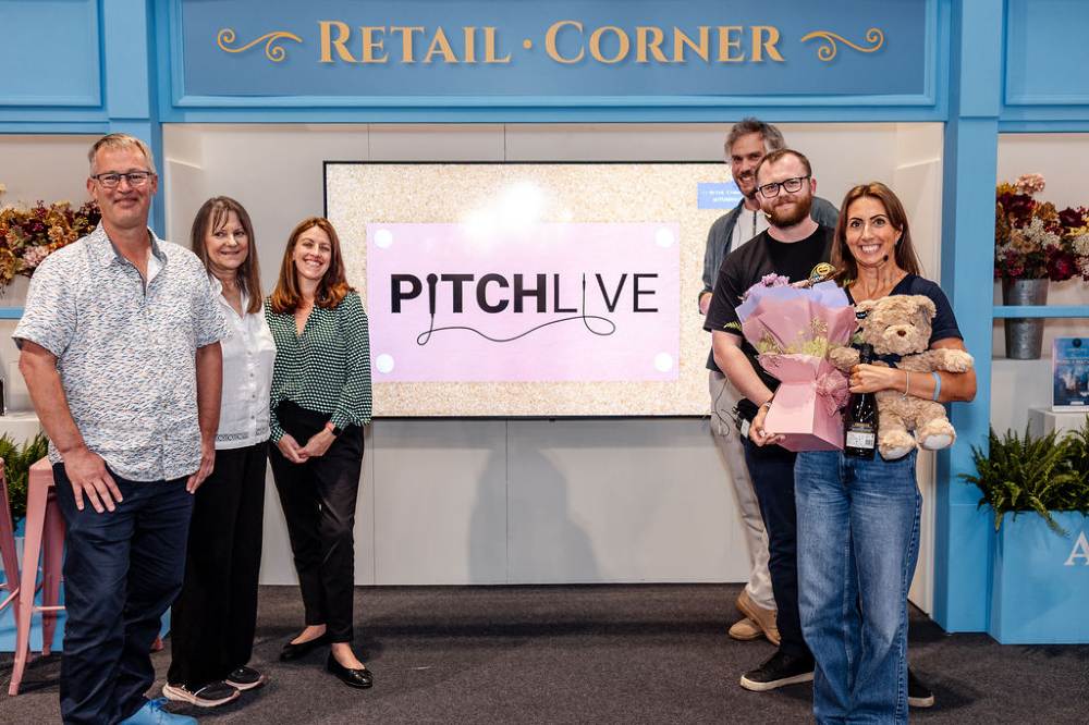 Peoplel stood on a stage in front of a Pitch Live sign at Autumn Fair 