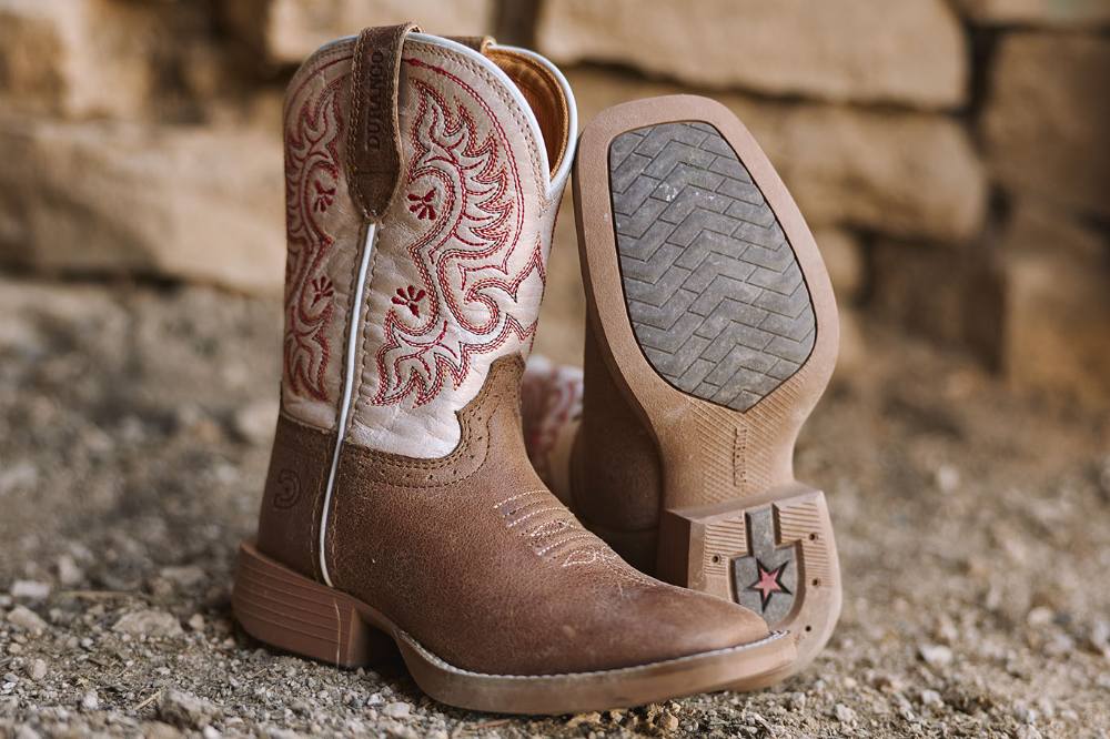 A pair of children's western boots displayed outside