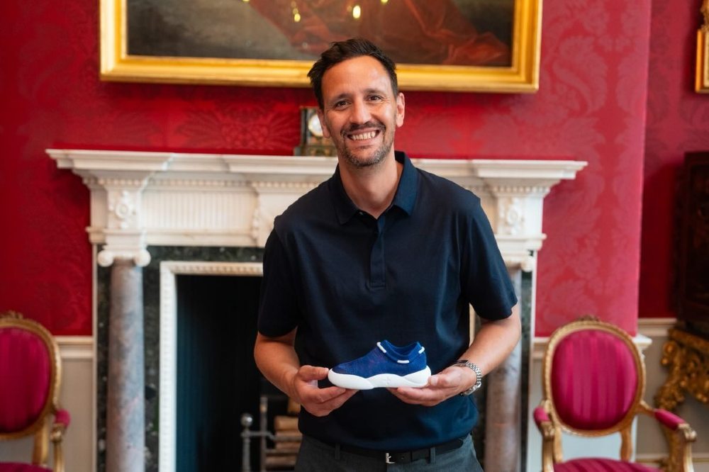 Stuart of Dubs holding a blue child's shoe