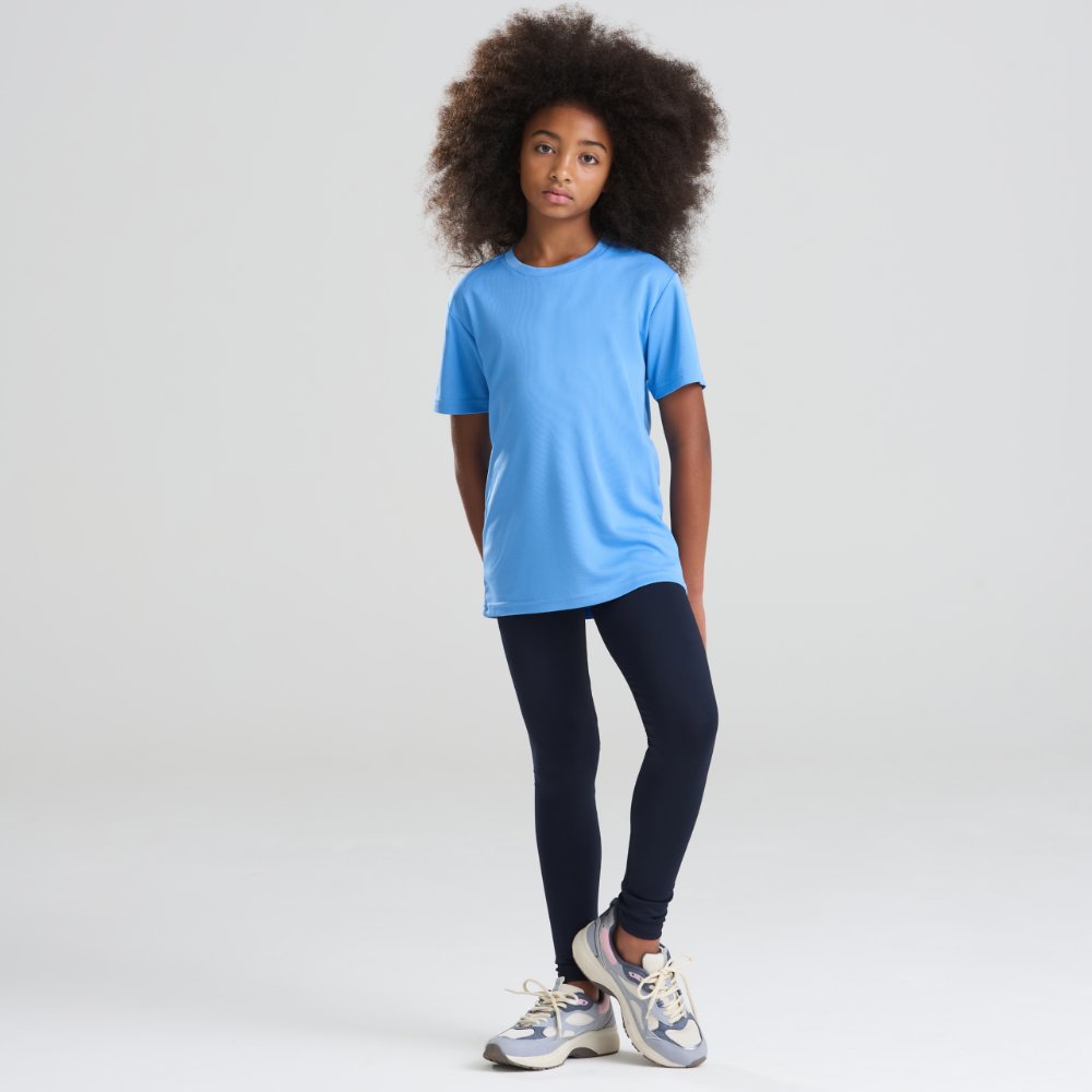 A girl stood in leggings and a blue T-shirt by AWDis