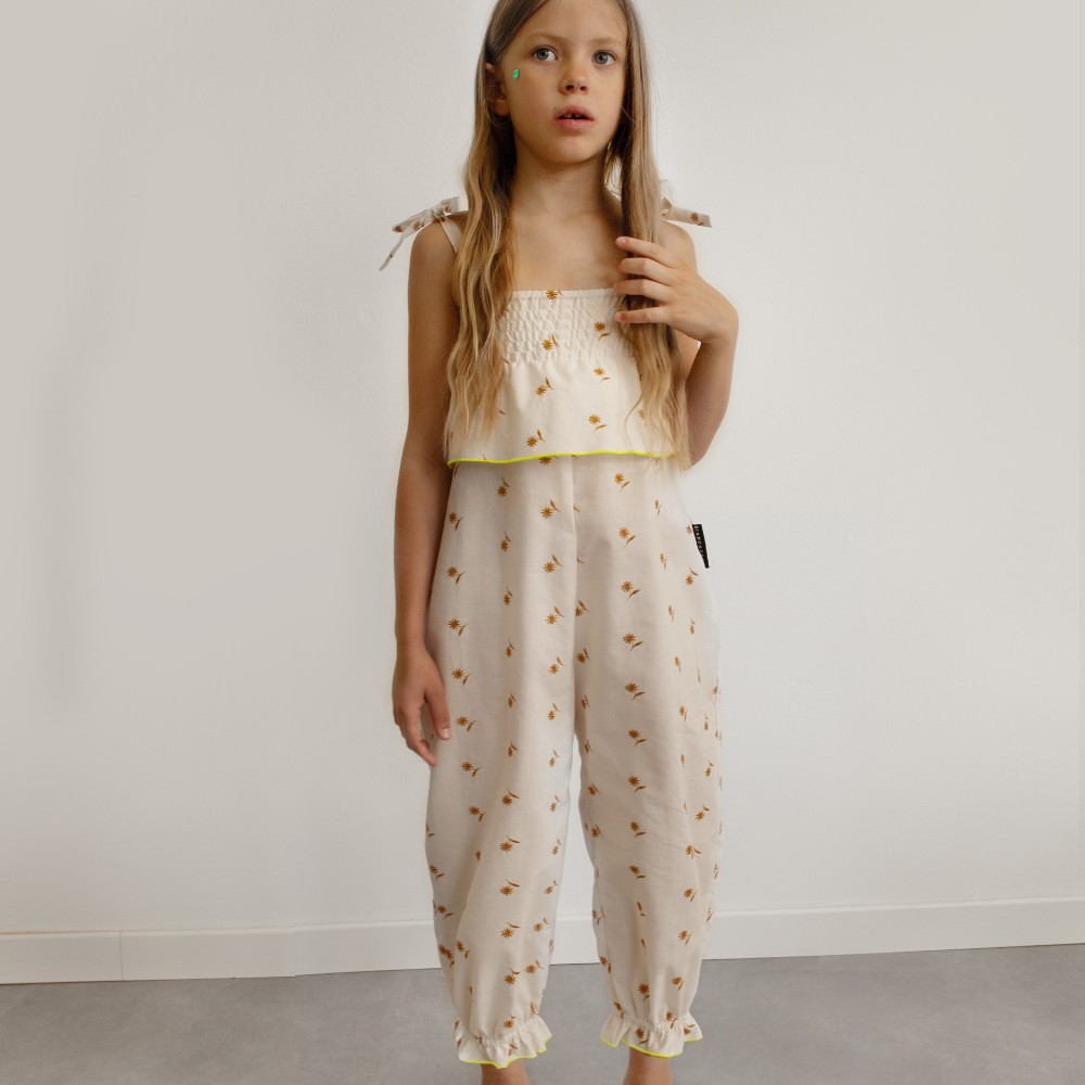 A girl stood in a matching summer top and trousers