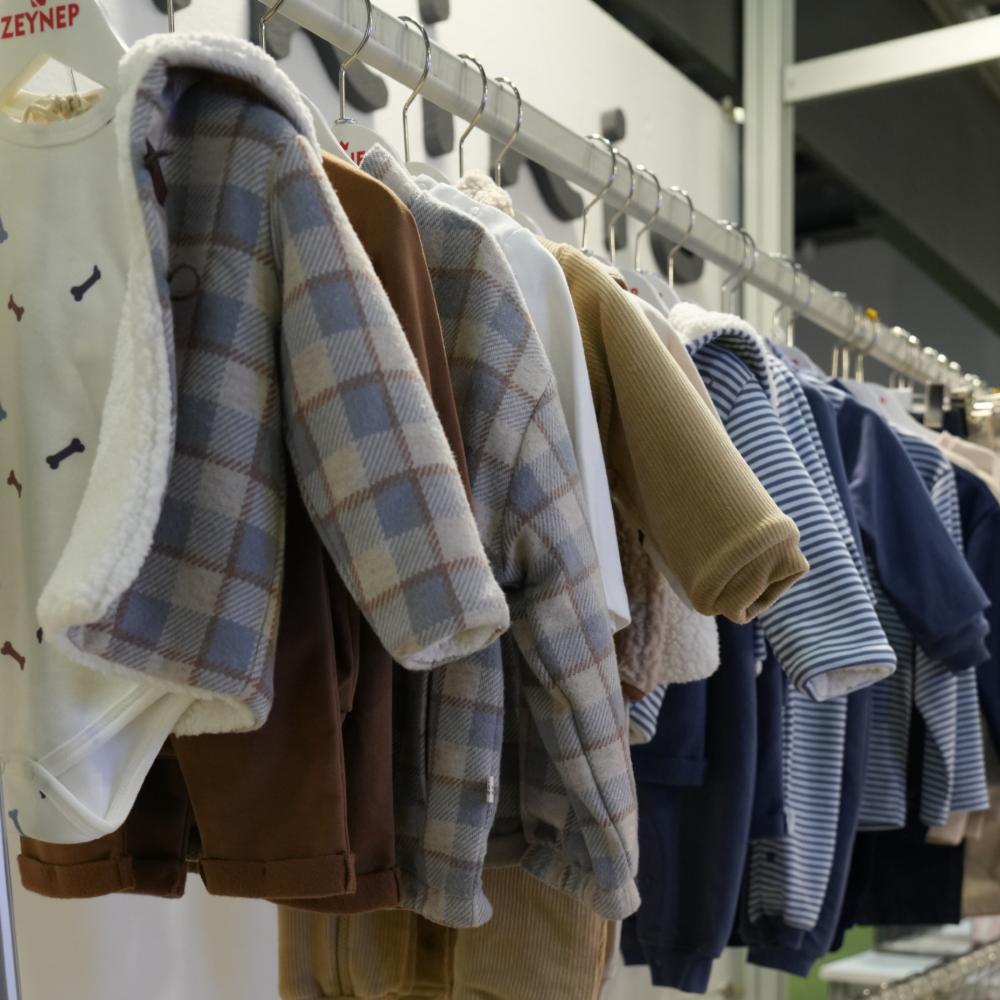Children's clothes hung on a rail on a childrenswear stand at IFCO Kids 