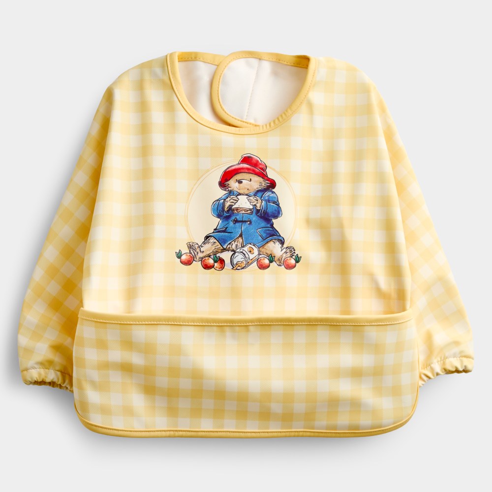 A yellow and white checked JoJo Maman Bebe x Paddington bib