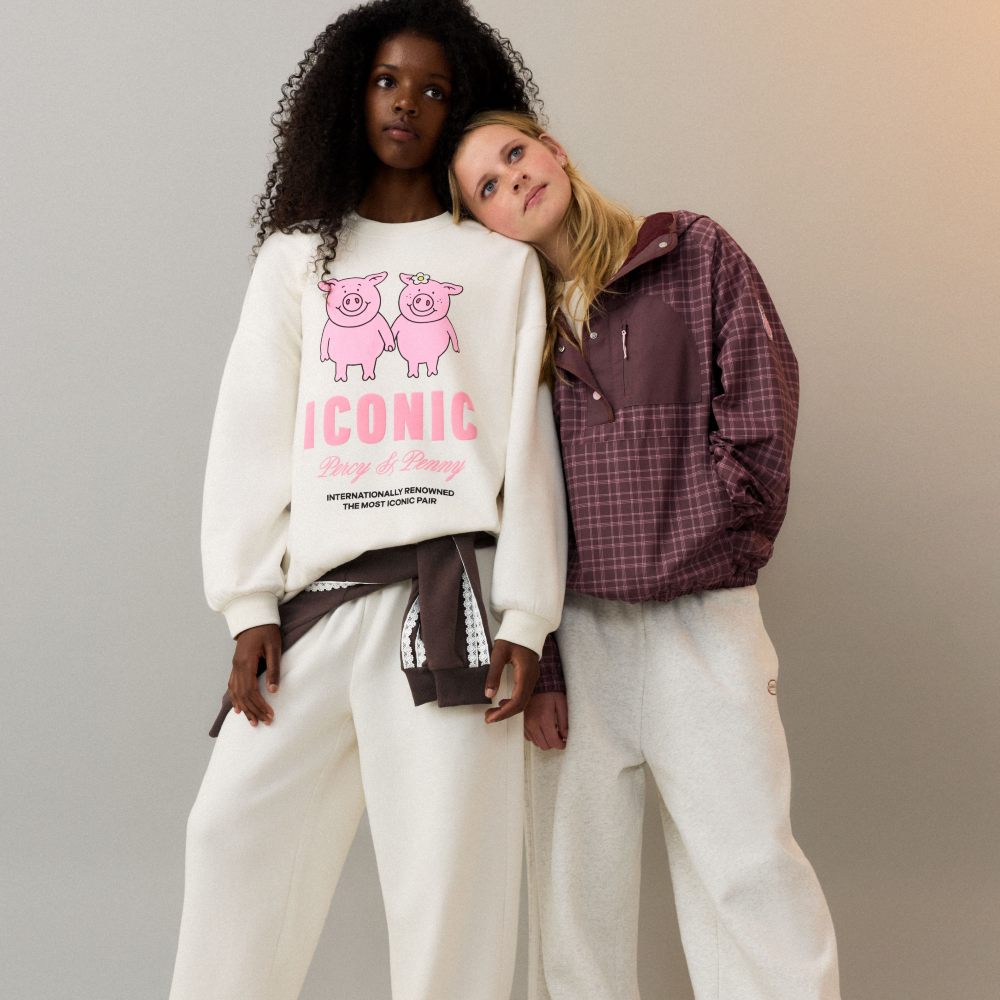 Two teenage girls stood together wearing casual outfits from the M&S Percy Pig fashion collection 