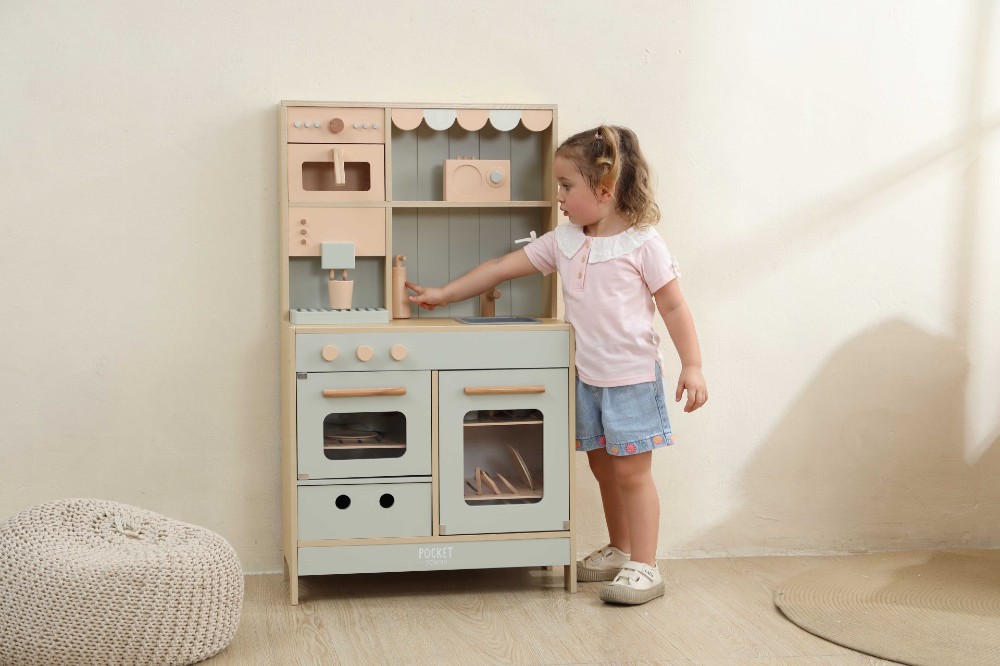 A child playing with a role-play kitchen by Pocket Towns 