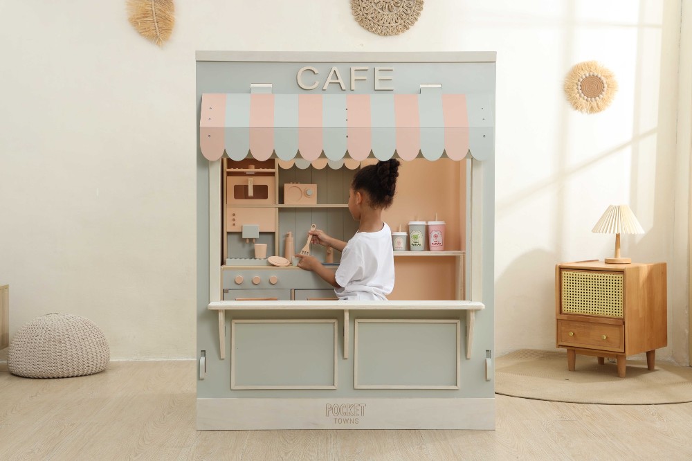 A child playing inside a role-play cafe by Pocket Towns