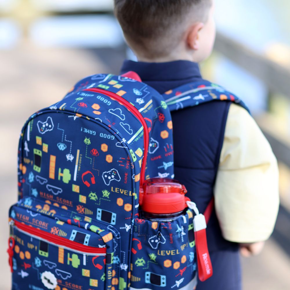 The back of a boy wearing a Roamie backpack