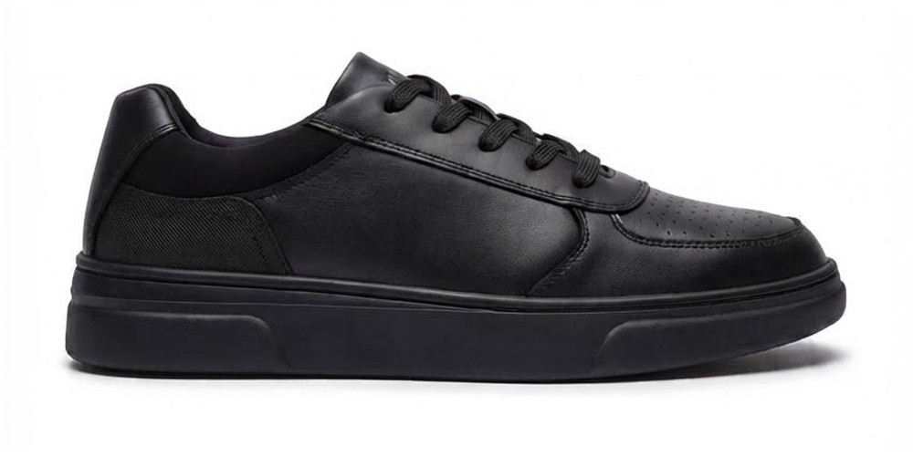 A black lace-up school shoe by Term Footwear shown against a white background 