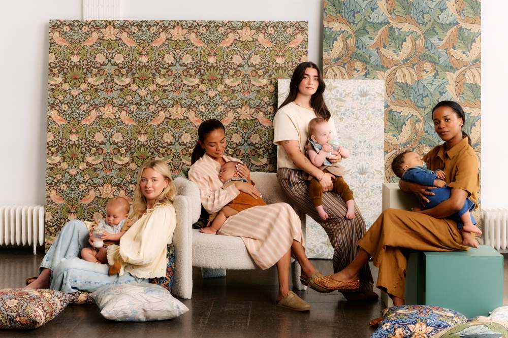 Four mothers sat together holding young children