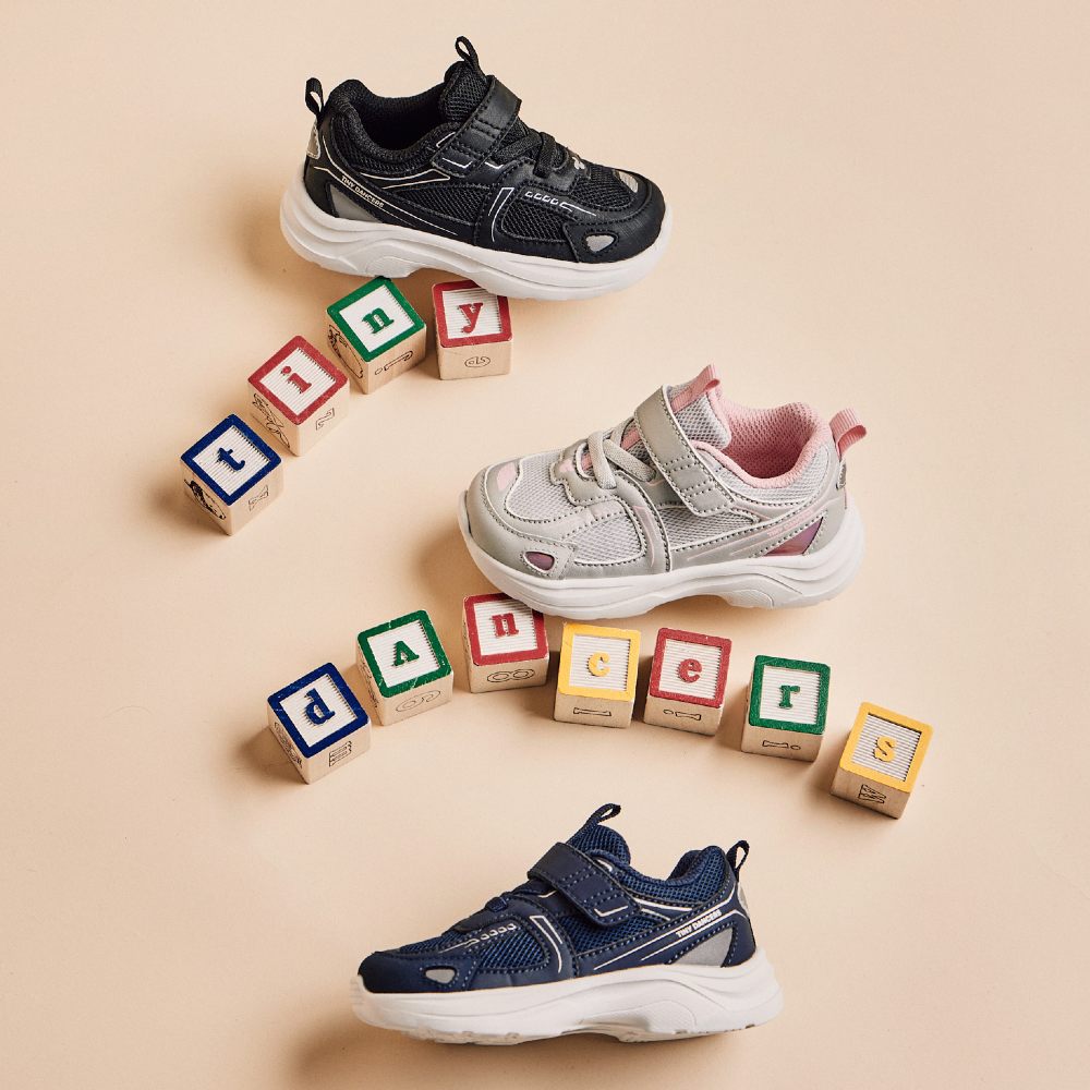 Children trainers displayed by building blocks spelling out Tiny Dancers 