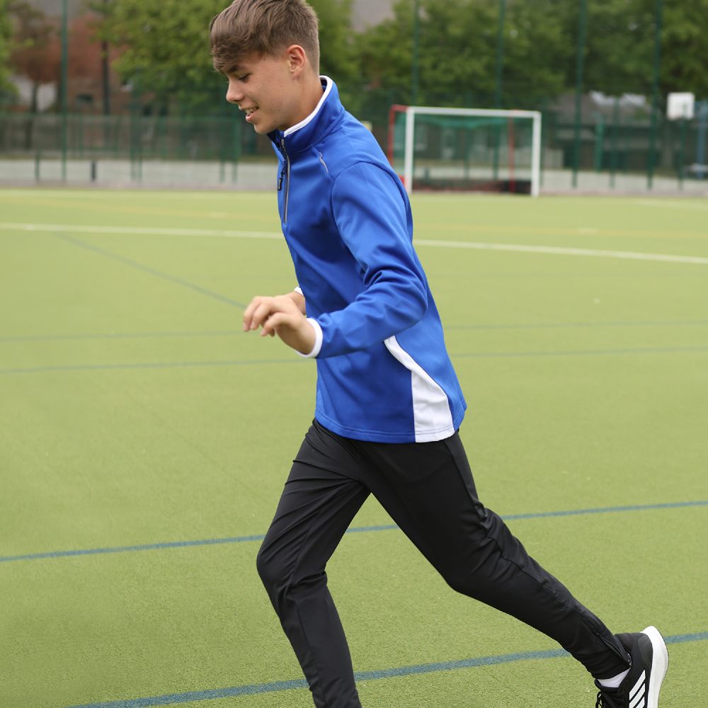 A school child playing football outside 