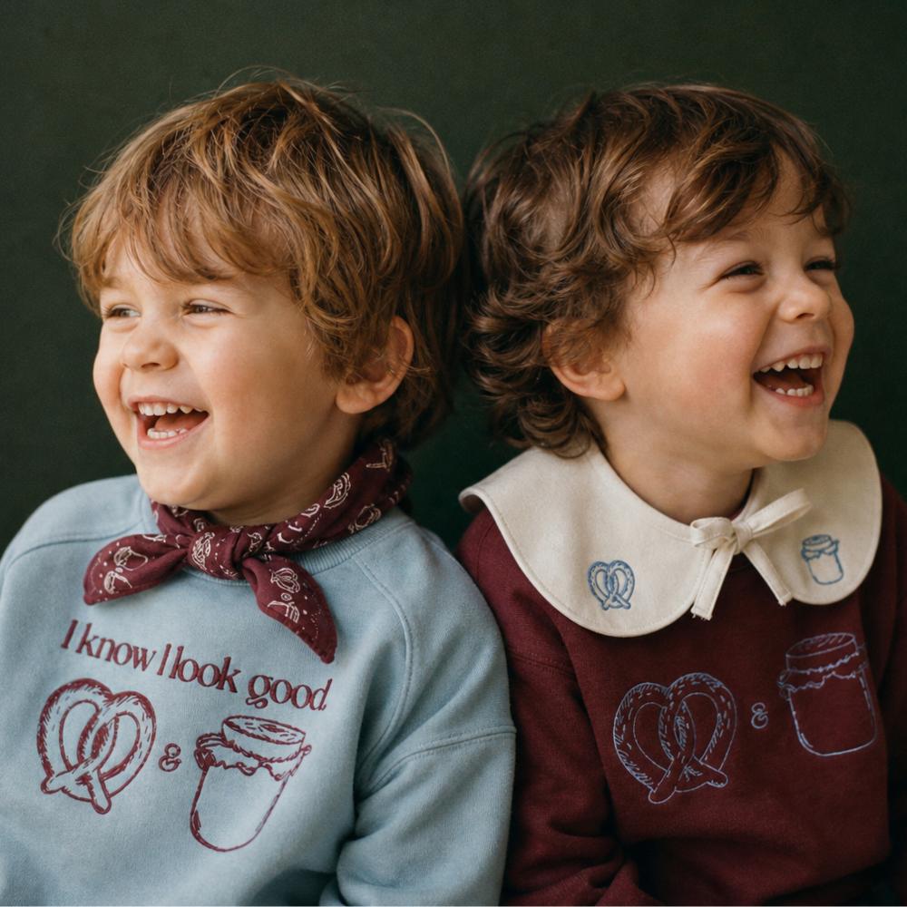 Two laughing children in sweatshirts 