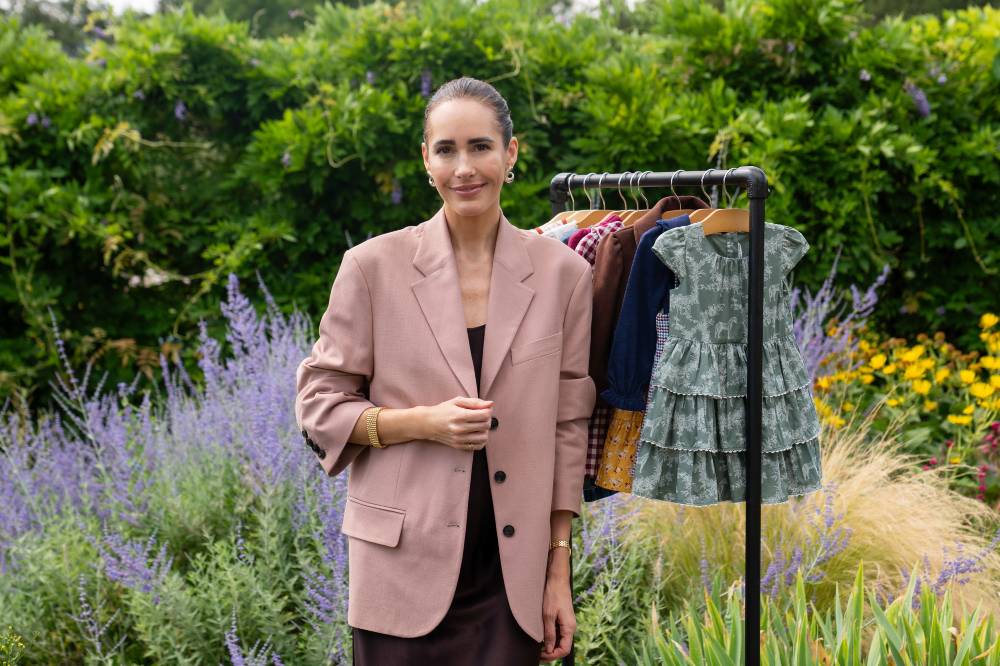 Louise Roe stood by a rail of children's clothes for her edit for Janie and Jack