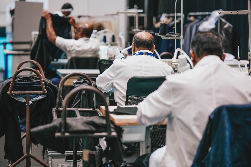 The backs of people working in a UK clothing factory